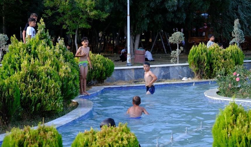 Van’da sıcaktan bunalan çocuklar, süs havuzunda serinledi